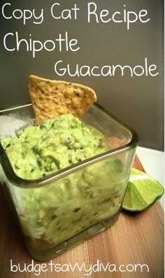 a glass bowl filled with guacamole and a tortilla chip