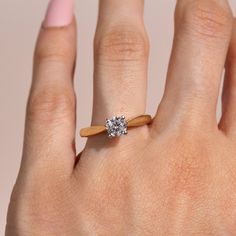 a woman's hand with a diamond ring on it