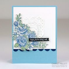 a close up of a card with flowers on the front and blue border around it