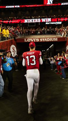 a football player is walking into the stadium