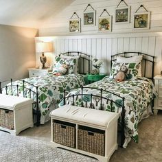 two twin beds in a bedroom with baskets on the nightstands next to each other