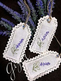 three tags with lavenders on them hanging from twine