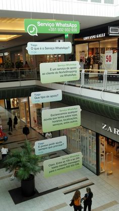 two people are standing in the middle of a shopping mall