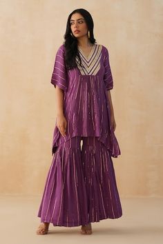 Purple textured kaftan with lace embroidered front yoke and cinched center waist. Paired with a matching textured sharara and an inner slip. - Aza Fashions V-neck Kaftan With Embroidered Neckline For Festive, Festive V-neck Kaftan With Embroidered Neckline, Festive V-neck Kaftan, Bollywood Style V-neck Kurta With Embroidered Neckline, Wedding Sets With Embroidered V-neckline, V-neck Embroidered Kaftan For Navratri, Embroidered V-neck Kaftan For Navratri, Festive Bohemian V-neck Set, V-neck Dress With Cutdana For Festive Season