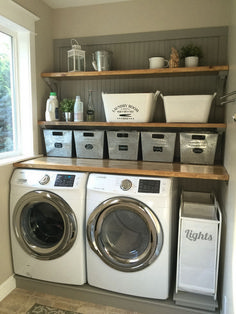 a washer and dryer in a laundry room with baskets on the shelves above them