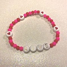 "❤️💗 This bracelet is the perfect addition to your Valentine's Day outfit! Add this little stacking bracelet to add some color to your V-Day jewelry! This bracelet features adorable pink and red beads with rose gold letters that spell out, \"LOVE.\" This bracelet is 6.5 inches. 💗❤️ Simple stacking bracelets are the easiest way to make yourself look put together any day of the week! Throw on your own custom stack of bracelets and voila! You're good to go!  These bracelets make the sweetest gift Stack Of Bracelets, Preppy Bracelets, Valentines Bracelets, Look Put Together, Diy Jewelry Unique, Stacking Bracelets, Beads Bracelet Design, Red Beads, Red Love