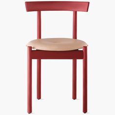 a red chair with a beige seat and back rest on a white background in front of the camera