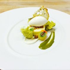 a white plate topped with food on top of a wooden table