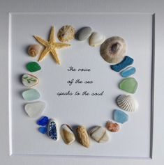 there is a frame with sea glass and seashells in the shape of a circle