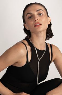 An '80s-inspired herringbone chain slinks around your neck in this shiny lariat necklace fixed with a slide closure to adjust the drop length. 24" length Adjustable slide closure Rhodium plate Imported