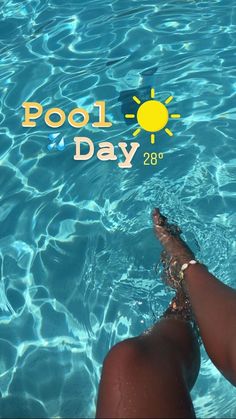 a person's feet in the water near a swimming pool with sun above them