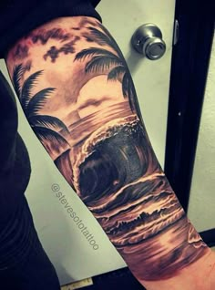 a man's arm with an ocean scene and palm trees on it