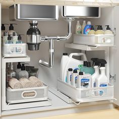 an organized bathroom cabinet with soap, shampoo and lotion in the bottom drawer