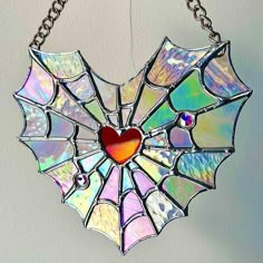 a stained glass heart hanging from a chain