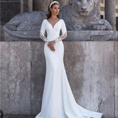 a woman standing in front of a lion statue wearing a white dress with long sleeves