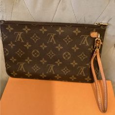 Authentic Louis Vuitton Pochette Monigram Leather Learner And Removable Strap Serial Code Good Condition Bag Is Pre Owed Expect Normal Wear Comes With Certificate Of Authenticity Designer Monogram Canvas Pouch, Luxury Handheld Pouch For Shopping, Designer Handheld Clutch For Shopping, Designer Handheld Clutch For Daily Use, Luxury Handheld Shopping Pouch, Luxury Clutch Bag For Errands, Designer Shopping Clutch Pouch, Designer Pouch Clutch For Shopping, Handheld Clutch With Gold-tone Hardware For Travel