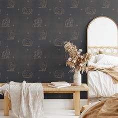 a room with a bed, table and wall paper