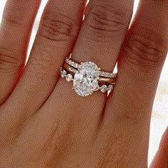 a woman's hand with a ring on it and a diamond in the middle