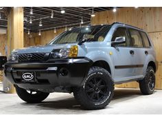 the front end of a grey suv parked in a garage