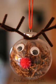 a glass ornament with reindeer's nose and antlers hanging from it