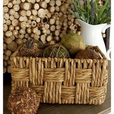 a wicker basket filled with lots of different types of items next to a white vase