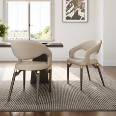 two beige chairs sitting in front of a window