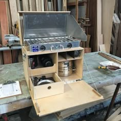 an old stove sitting on top of a wooden table