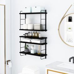 a bathroom with white walls and black shelves