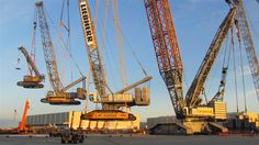 several cranes are in the middle of a construction site