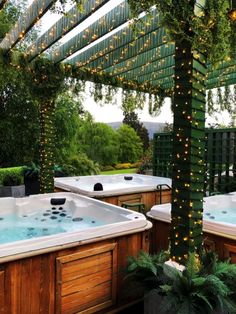 an outdoor hot tub with lights on it