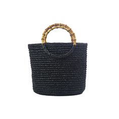 a small black basket with bamboo handles on the front and side, against a white background