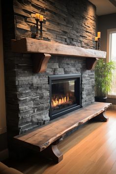 a stone fireplace in a living room with wood flooring