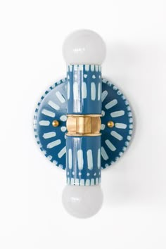 a blue and white wall mounted light fixture