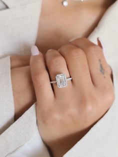 a woman's hand with a diamond ring on it