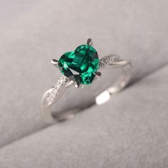 ◆ The ring is handcrafted from sterling silver and decorated with a dazzling 8*8 mm Lab Grown Emerald and CZs. It is suitable for engagement/anniversary/daily occasion. ◆ Production Description: Main stone Type: Lab Grown Emerald Main Stone Shape: Heart Cut Main Stone Size: 8*8 mm(1.59ct) Side stone: CZ Metal: 925 Sterling silver - Other options available in the drop down menu ◆ Customization: √Free for Add Engraving √Other Metal Type Available √Other Gemstones & Shapes Available √Personaliz Valentine's Day Moissanite Ring With Center Stone, Valentine's Day Moissanite Ring, Moissanite Heart Ring With Round Cut For Gifting, Moissanite Heart Ring With Center Stone For Promise, Green Fine Jewelry Heart Ring For Wedding, Green Heart Cut Rings For Wedding, Moissanite Heart Ring For Promise, Heart-shaped Moissanite Promise Ring, White Gold Moissanite Heart Ring As A Gift