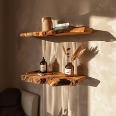 two wooden shelves with bottles and candles on them