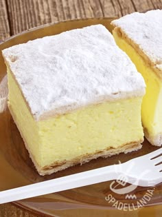 two pieces of cake sitting on top of a glass plate with a fork next to it