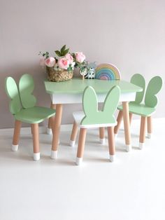 a table and chairs with bunny ears on them