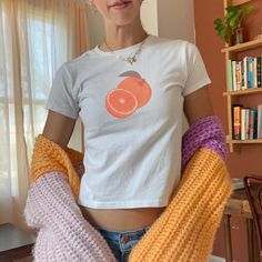 Brighten up your wardrobe with our orange baby tee! 🍊 This vintage fruit shirt is perfect for your farmers market or summer harvest. Embrace 2000s fashion with this vintage-style graphic crop top, adding a fresh and playful touch to your collection. Click now to add it to your cart and enjoy the zest of summer! 🫧 SIZING * Available sizes: XS -XL * This garment is true to size, but size down if you prefer a more fitted look. * Keep in mind, this garment is in youth sizing to achieve the baby te Orange Fitted Cotton Tops, Fitted Cotton Orange Tops, Cute Orange Cotton Shirt, Trendy Orange Cotton Shirt, Fitted Orange T-shirt For Spring, Trendy Short Sleeve Apricot Top, Cute Orange Crew Neck Top, Trendy Orange Crew Neck Shirt, Trendy Apricot Short Sleeve Top