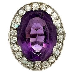 Antique Edwardian platinum diamond oval amethyst ring, circa 1910. This gorgeous ring is beautifully made centering on an oval amethyst with a rich purple hue. The ring has a halo of 26 old European cut diamonds weighing 0.90 carats approximately. The diamonds are H to J color and VS clarity. The ring has a gorgeous platinum gallery underneath the stone. There are numbers on the ring pointing to a fine craftsman or jewelry store made and sold the ring, it is also stamped Platinum. The ring is a Luxury Oval Amethyst Ring With Center Stone, Luxury Oval Amethyst Ring With Diamond Accents, Art Deco Oval Purple Amethyst Ring, Oval Purple Amethyst Ring With 17 Jewels, Antique Oval Amethyst Ring With Center Stone, Oval Amethyst Ring With Diamond Accents, Art Deco Oval Amethyst Ring, Oval Purple Platinum Rings, Heirloom Style Purple Oval Amethyst Ring