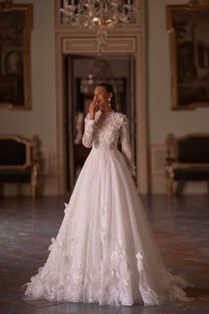 a woman in a wedding dress talking on her cell phone