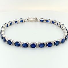 14k Sapphire Diamond Tennis Bracelet  Prong Set BLUE SAPPHIRES- SHAPE: Oval SIZE: 5x4mm # OF STONES: 26 WEIGHT: 13.77 carats DIAMOND- # OF STONES: 52 WEIGHT: 0.52 carats Gold Weight: 9.38 grams Sapphire Tennis Bracelet With Round Diamonds, Classic Sapphire Tennis Bracelet With Prong Setting, Sapphire Diamond Tennis Bracelet With Round Shape, Sapphire Diamond Tennis Bracelet With Round Cut, Classic Sapphire Tennis Bracelet With Round Shape, Classic Sapphire Tennis Bracelet For Anniversary, Blue Round Tennis Bracelet With Prong Setting, Blue Tennis Bracelet With Prong Setting, Classic Sapphire Gemstone Tennis Bracelet