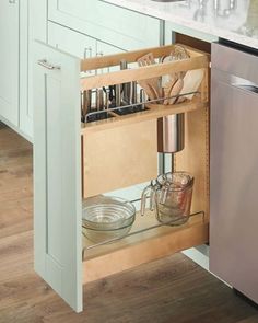 an open pull out drawer in a kitchen