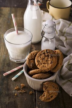 chocolate chip cookies and milk on a wooden table - stock photo - images in high resolution