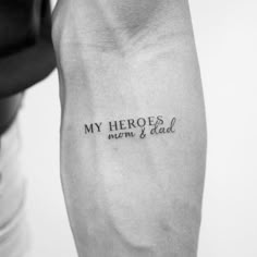 a person with a tattoo on their arm that says, my hero is mom and dad