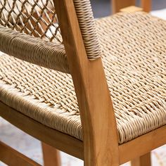 a wooden chair with wicker seat and backrests on carpeted flooring