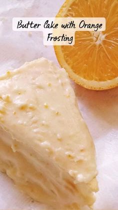 a piece of cake with orange frosting next to an orange slice