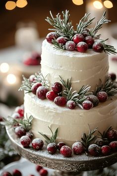 a three tiered cake with frosting and cranberries