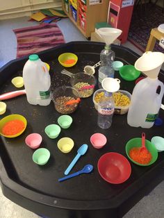 various bowls and spoons are arranged on a table