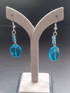 Blue French Hook Jewelry As Gift, Blue Metal Crystal Earrings With Ear Wire, Blue Crystal Earrings With Metal Ear Wire, Light Blue Metal Earrings As A Gift, Light Blue Metal Earrings For Gift, Blue Metal Dangle Hoop Earrings, Blue Nickel-free Drop Earrings, Blue Metal Beaded Drop Earrings, Blue Round Crystal Earrings In Metal